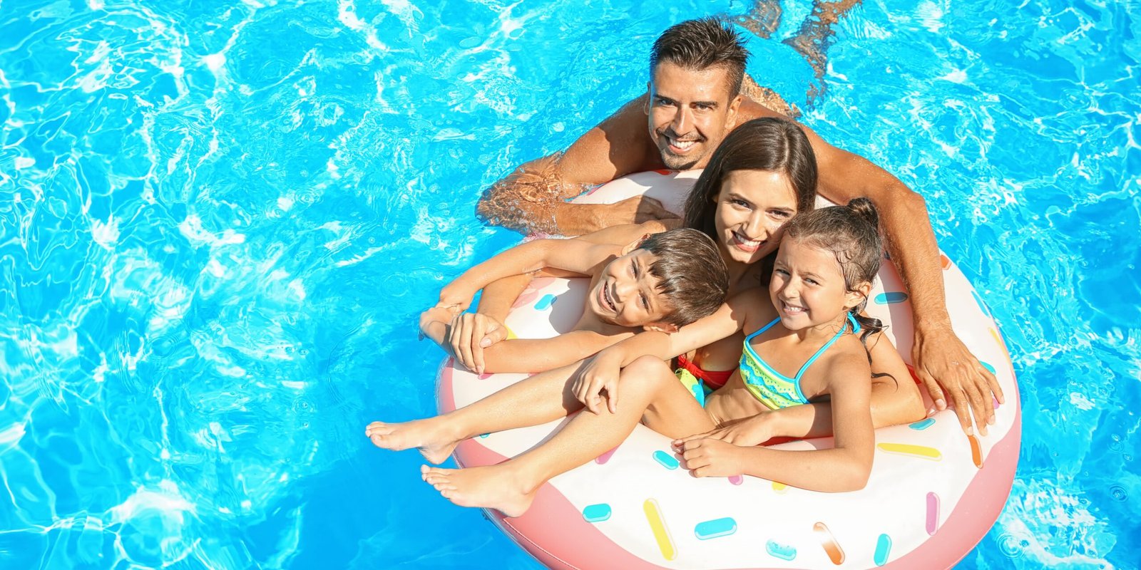 a family floating in pool